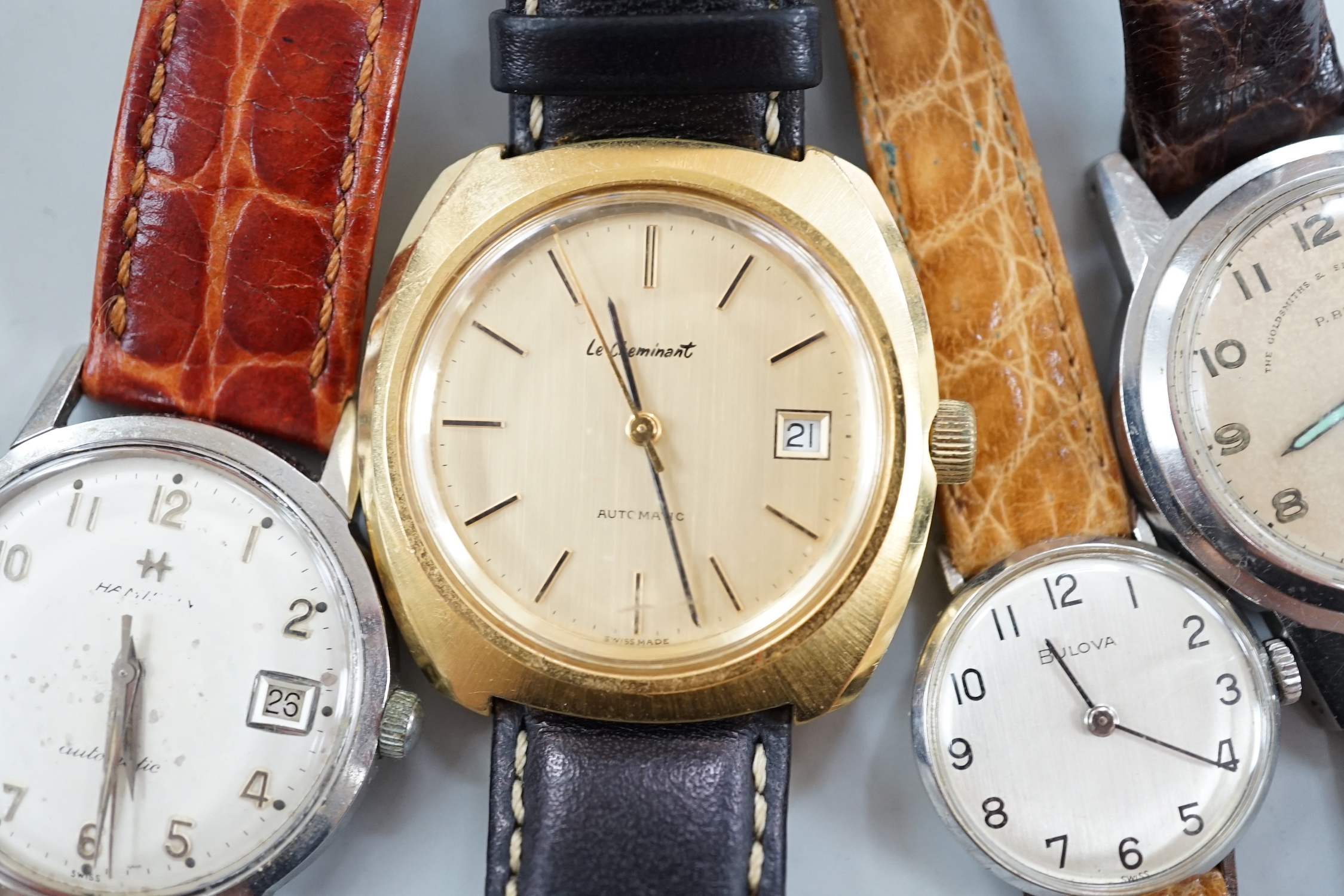 Three assorted gentleman's steel or gilt wrist watches, including retailed by Buhre and a lady's steel manual wind Bulova watch.